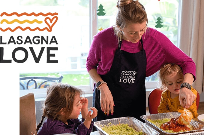 Mother making lasgna with kids