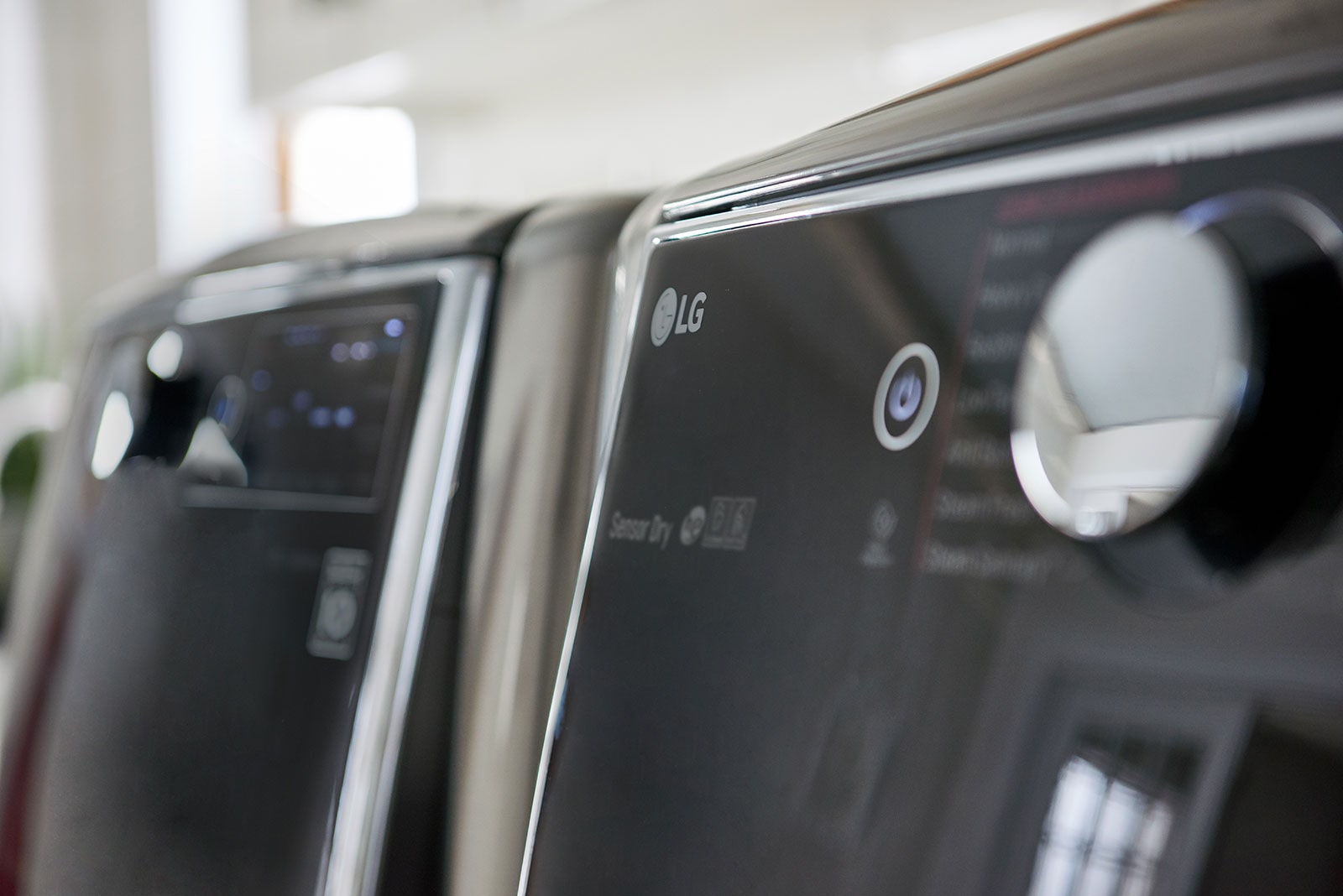 A closeup of the knobs and control panel on an LG washer and dryer.