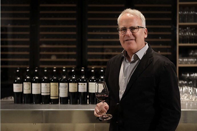 James suckling is standing next to the table.