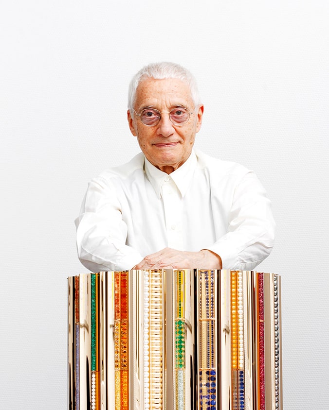 Alessandro Mendini was looking straight ahead with hist artistic sculpture.