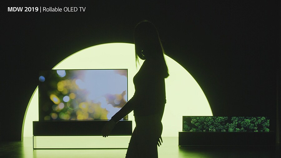 someone is walking on the stage of lg signature oled tv r at milan design week 2019
