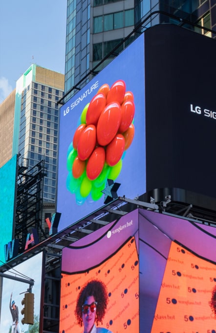 LG SIGNATURE advertisement picture displayed on a billboard on Times Square street.