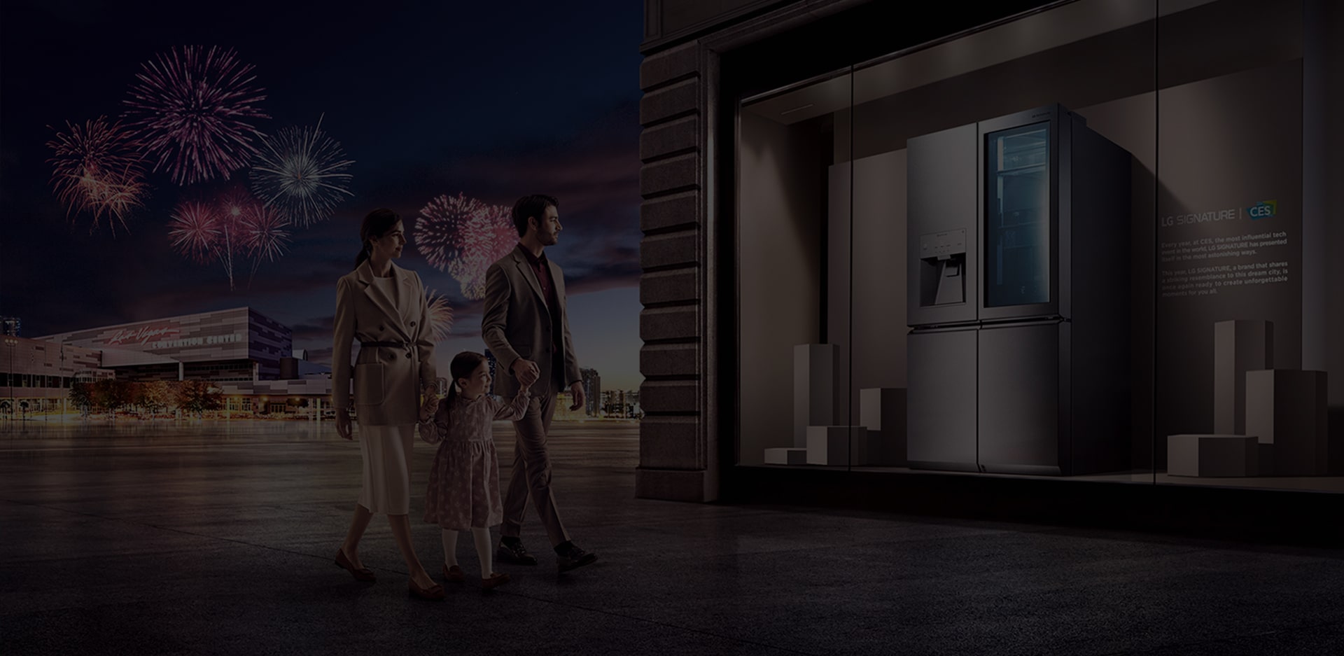 A family of three observes the LG SIGNATURE Refrigerator on display at the CES gallery, while fireworks set off behind them.