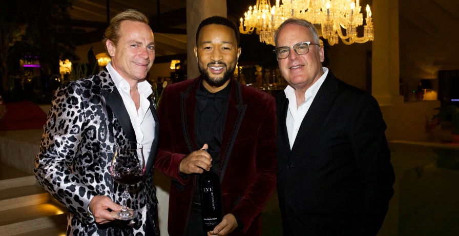 Jean-Charles Boisset, John Legend, and James Suckling pose together for a photo.