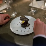 A plate of chocolate dessert sits on a dinner table at the event.