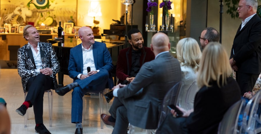 Surrounded by others also in the audience, Jean-Charles Boisset, Brandt Varner, and John Legend interact with James Suckling, who led the talk session.