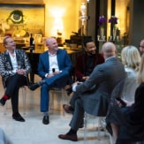 Surrounded by others also in the audience, Jean-Charles Boisset, Brandt Varner, and John Legend interact with James Suckling, who led the talk session.
