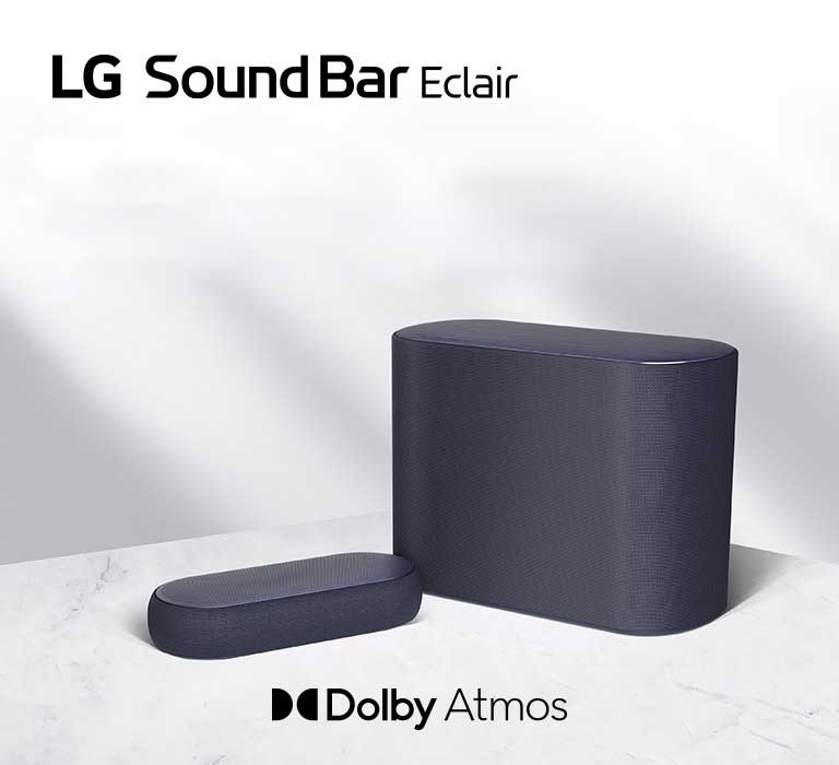 LG Éclair and subwoofer are placed on a white marble floor, slightly tilted.
