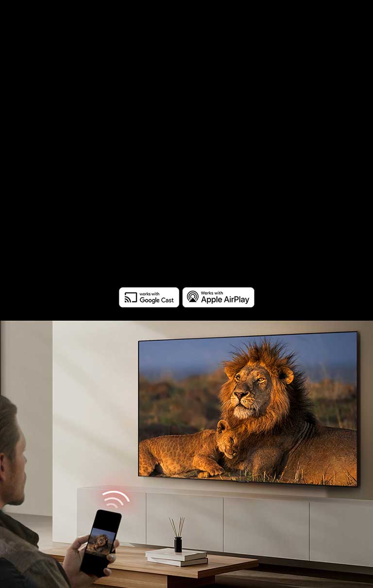 Yashash xonasidagi devorga o‘rnatilgan LG TV, unda sher va sher bolasi ko‘rsatilgan. Bir odam qo‘lida xuddi o‘sha sherlarni ko‘rsatayotgan smartfon bilan old rejada o‘tiribdi. Smartfon ustida televizor tomon yo‘naltirilgan uchta egilgan neon qizil polosa tasviri ko‘ratilgan.