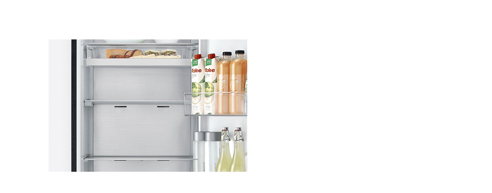 image shows how folding shelf is operated. By simply sliding it back, more space is created to store tall bottles.