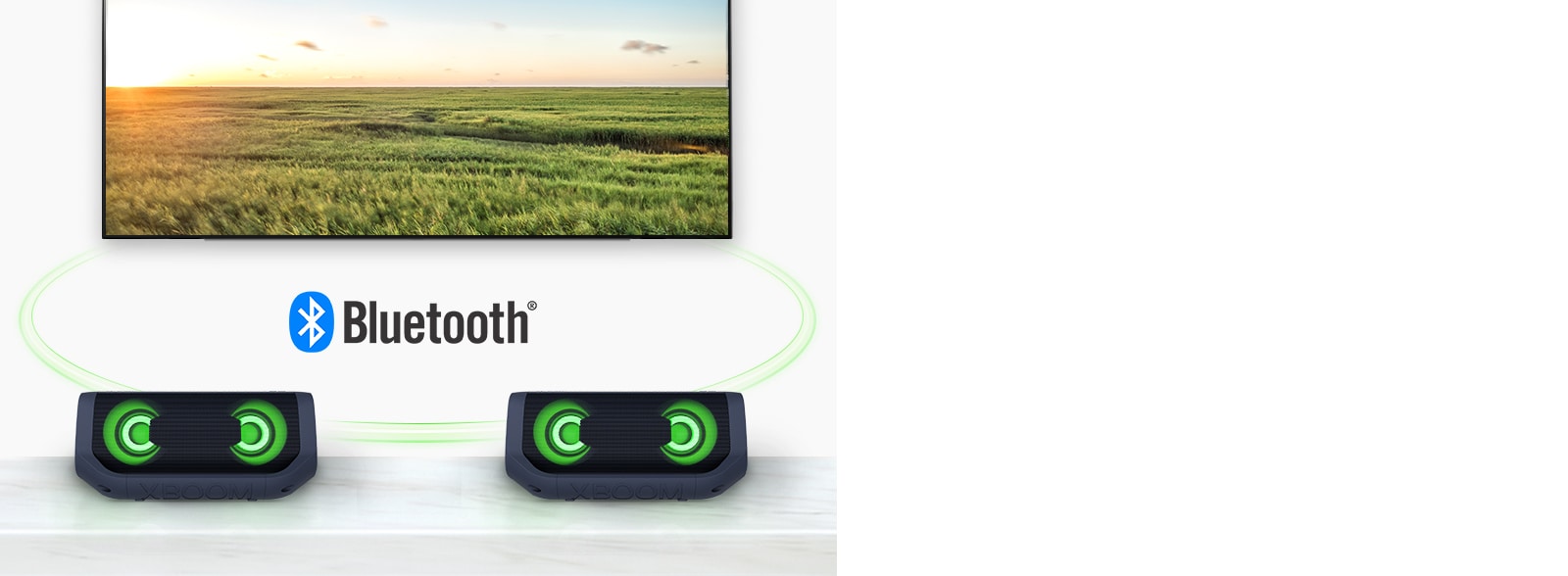 On a table, two LG XBOOM Go with green lighting are in front of a TV showing a field.