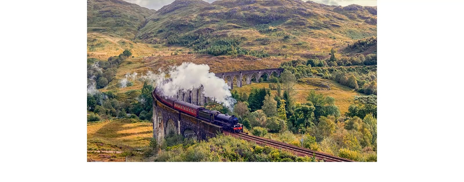 A train giving off steam on the rail is in the middle of the mountain with the a5 AI Processor 4K logo on the bottom left.