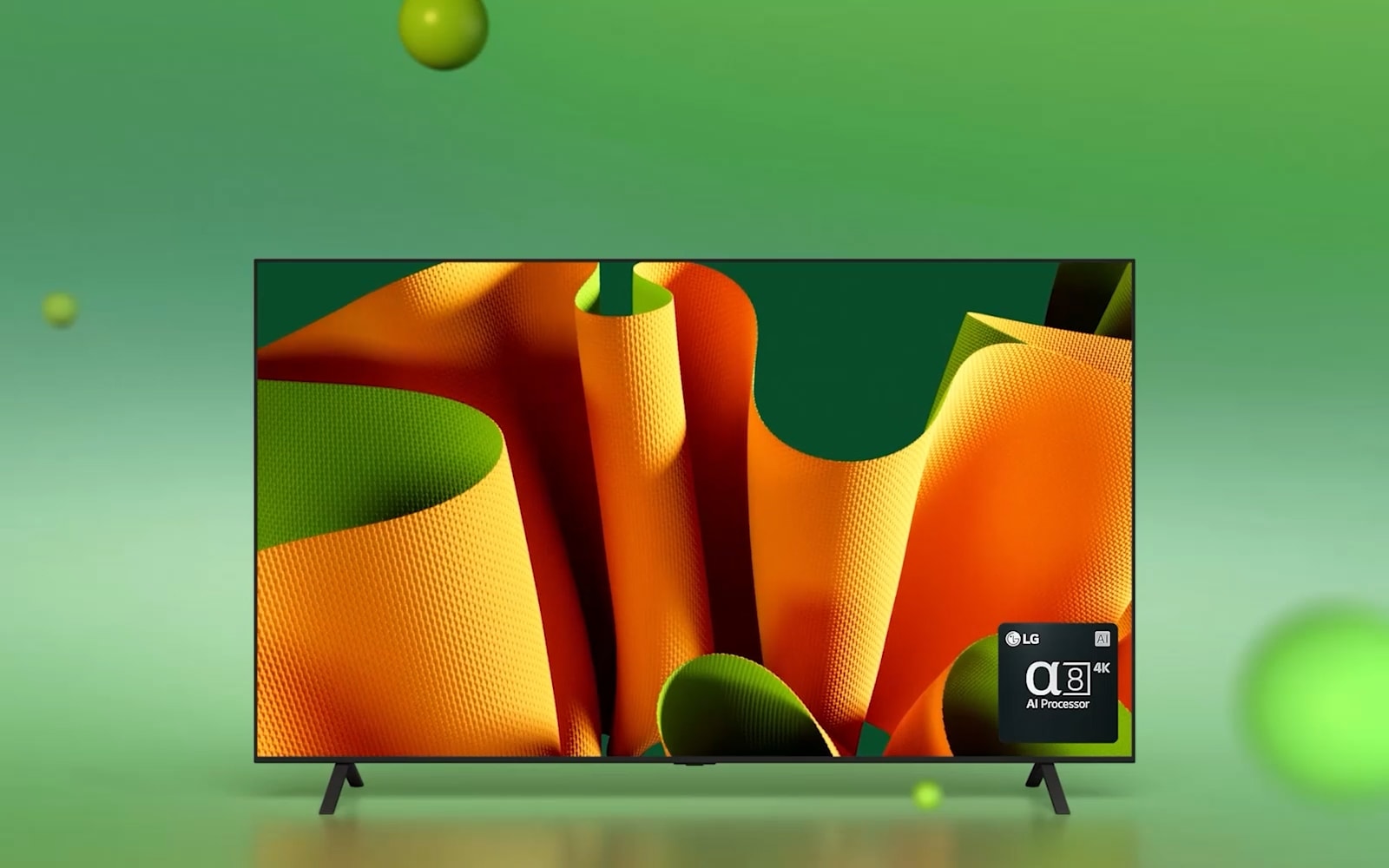 LG OLED B4 facing 45 degrees to the left with a green and orange abstract artwork on screen against a green backdrop with 3D spheres. The OLED TV rotates to face the front. On the bottom right there is an logo of LG alpha 8 AI processor.