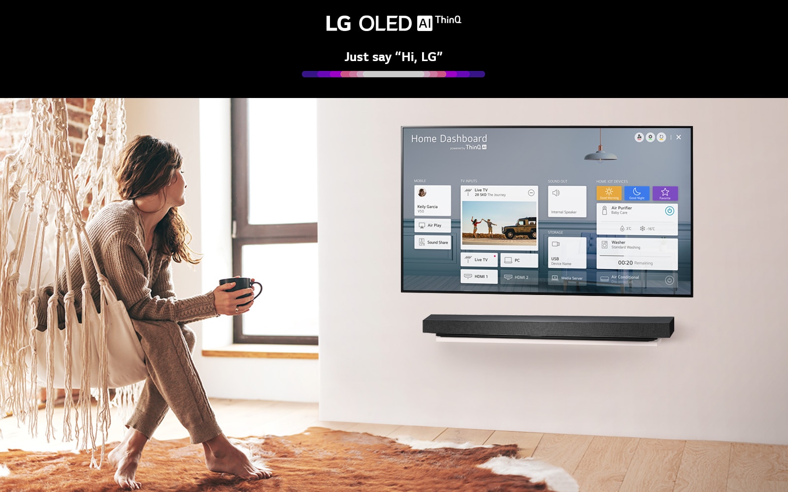 Woman sitting on a chair in the living room with the Home Dashboard on the TV screen