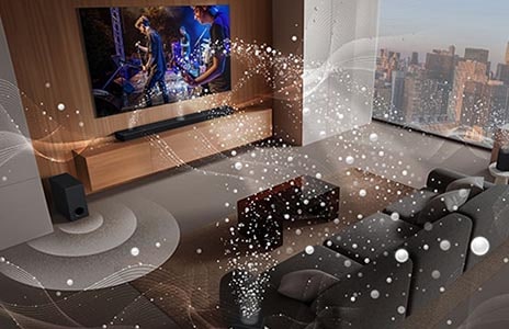 LG TV, LG Soundbar, rear speakers and a subwoofer are in a living room of a skyscraper, playing a musical performance. White soundwaves made up of droplets project from the soundbar and rear speakers, looping around the sofa and living space. A subwoofer is creating a sound effect from the bottom.