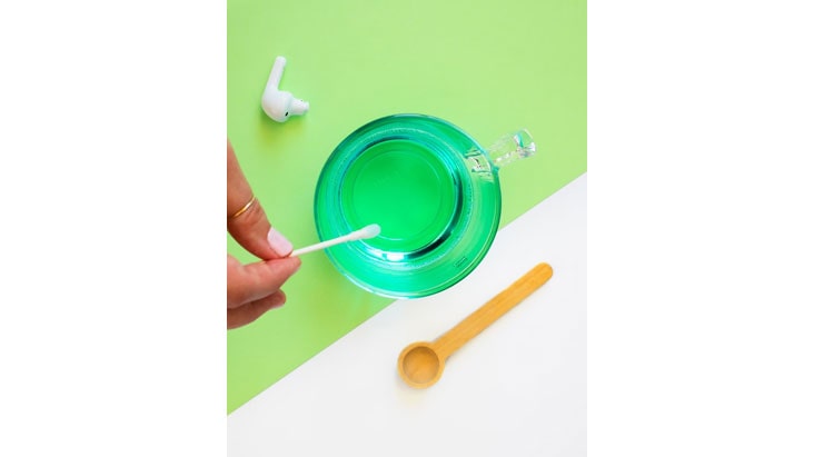 Cleaning earbuds with antibacterial soap.