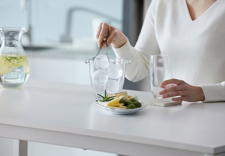 A woman is making ice balls at home.