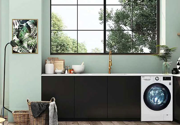 The LG TrueSteam washing machine featured in a home laundry room.