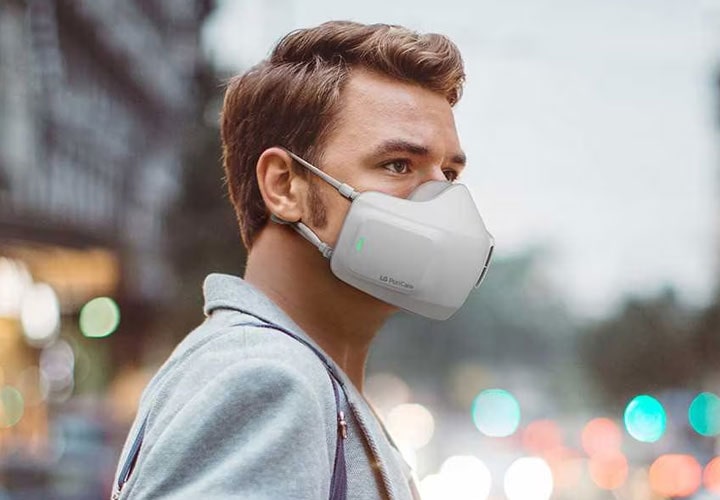 A man wearing the LG PuriCare™ Wearable Air Purifier in public.