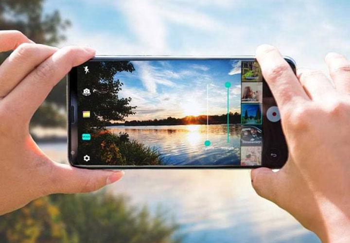 Two hands which are taking a photo to a river with LG V30.