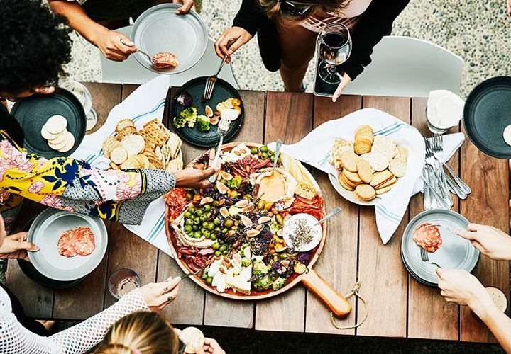 Friends enjoy a holiday meal before storing food in the fridge