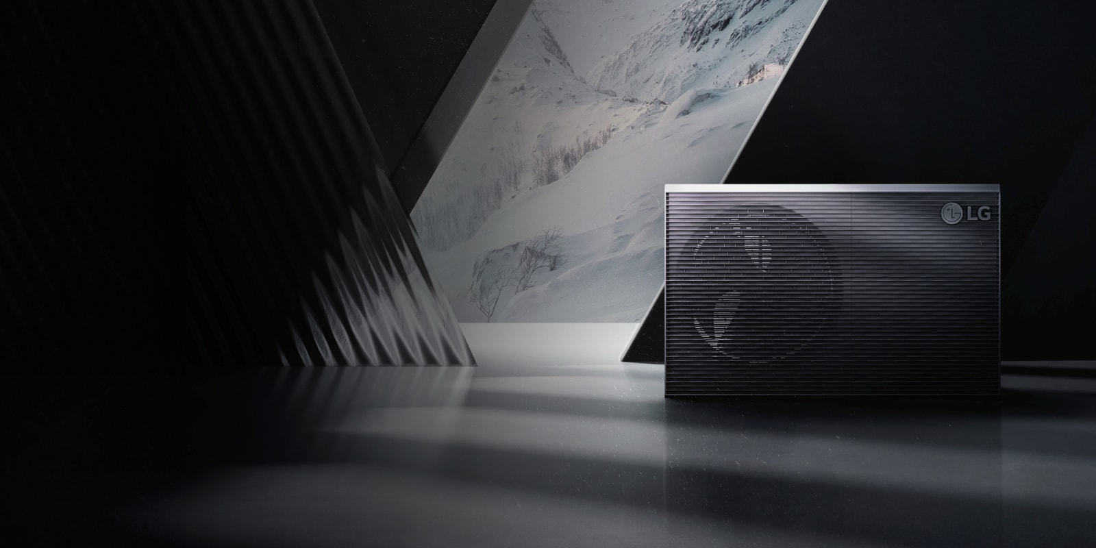 Air-to-water heat pump unit positioned against a snowy mountain backdrop, symbolising efficient and sustainable heating solutions.