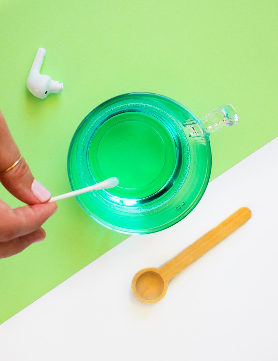 Cleaning earbuds with antibacterial soap.