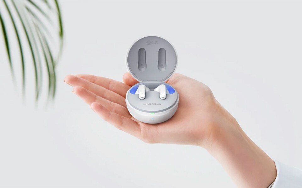 A pair of earbuds in a UVnano charging case.