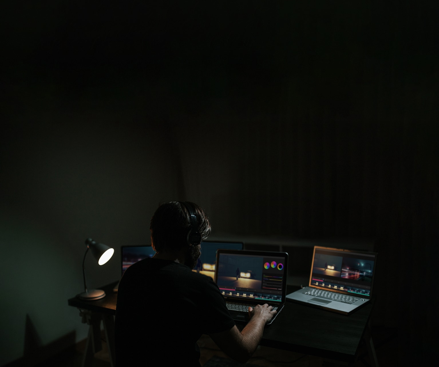 A man edits a movie while looking at the software on a computer monitor