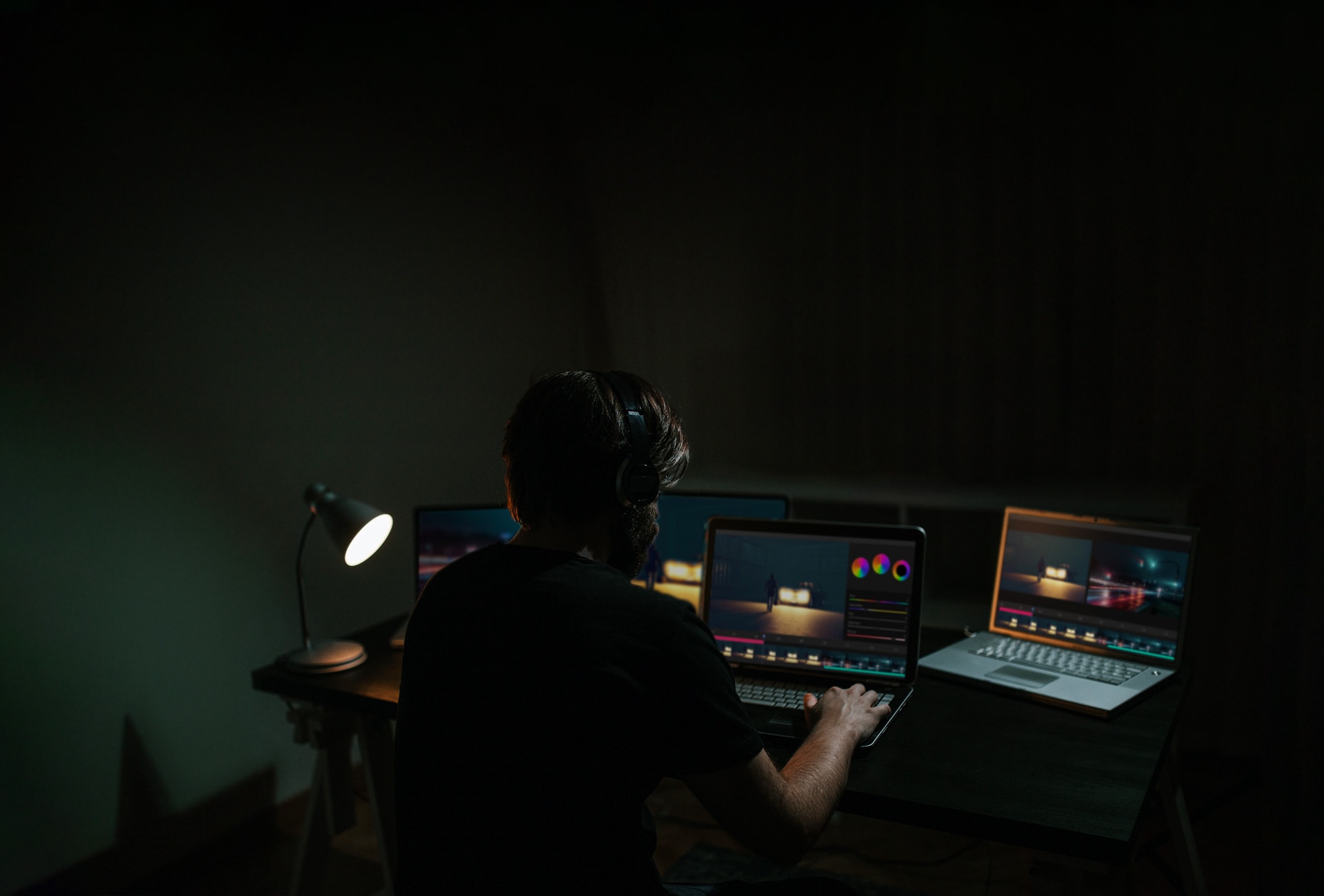 A man edits a movie while looking at the software on a computer monitor