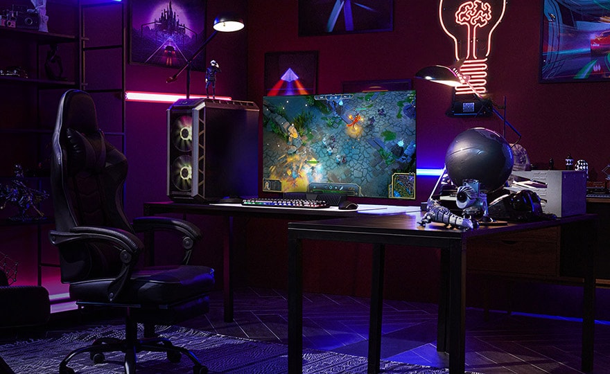 A man plays a game on the smallest LG OLED television while sitting at a desk