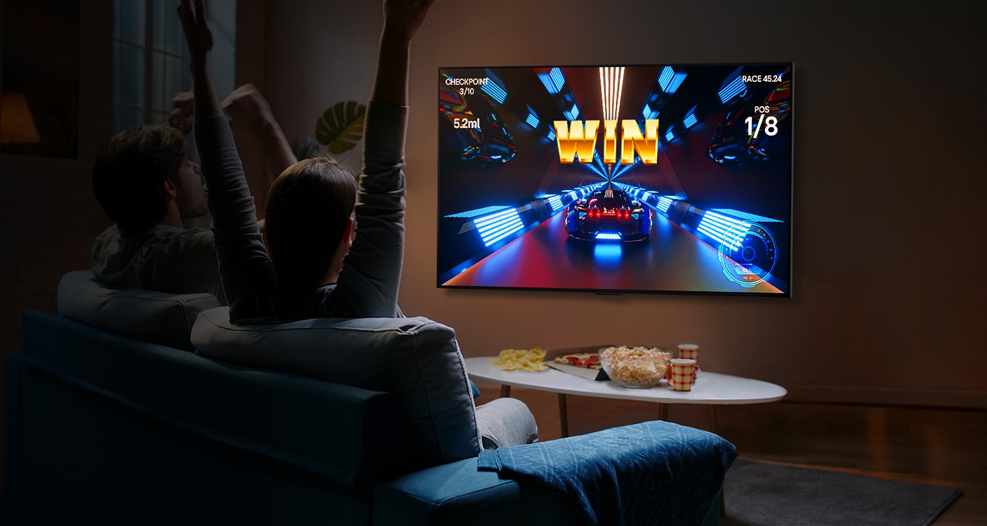 People play a game with a controller on the LG OLED television