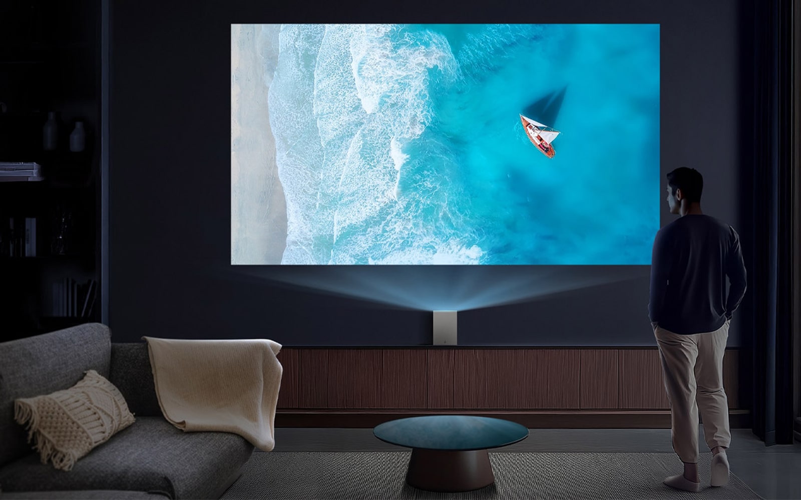 A man watching an LG OLED TV in the living room.